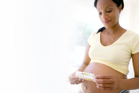 Pregnant woman reading a test for gestational diabetes